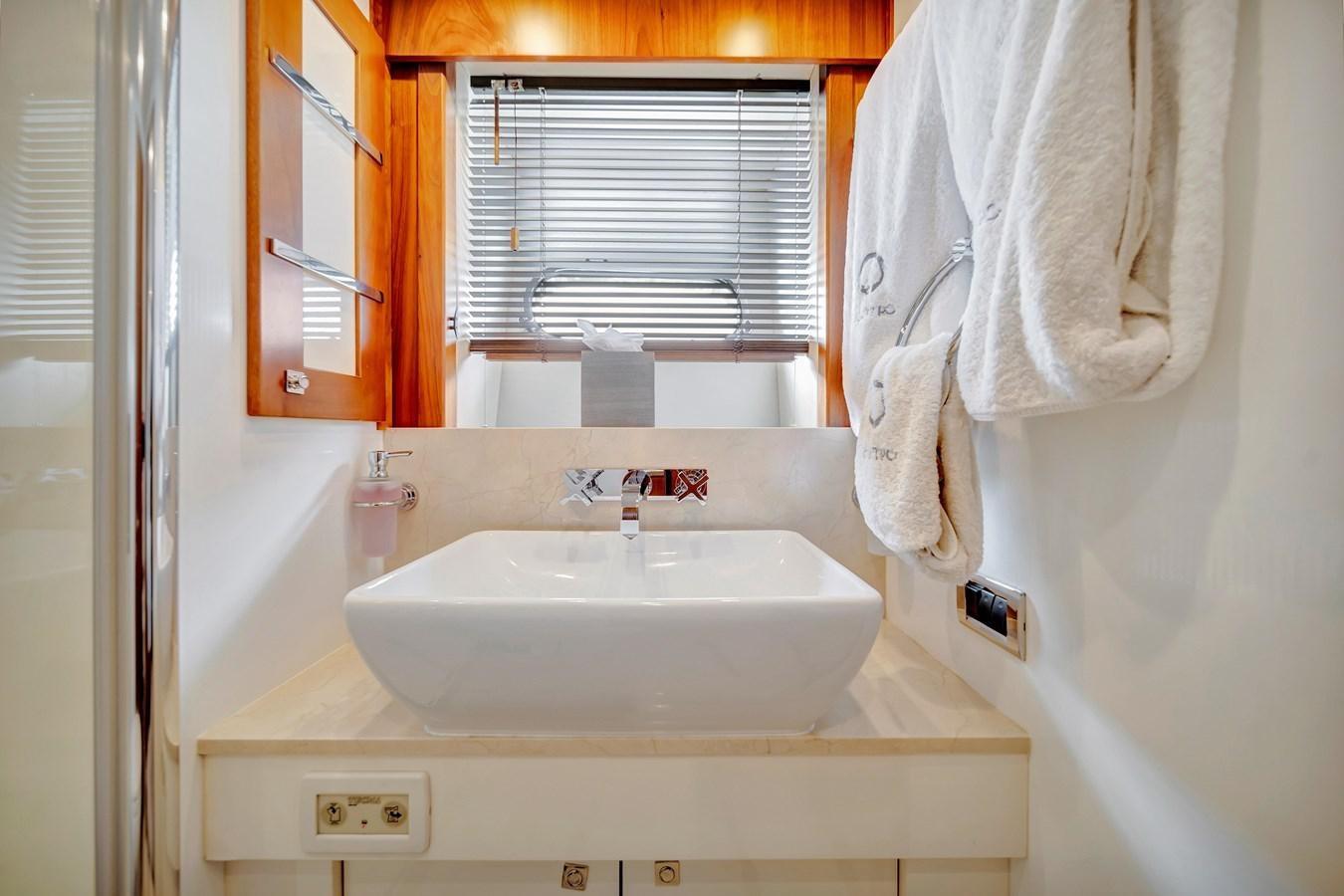a bathroom sink with a towel on the wall aboard QUATTRO Yacht for Sale