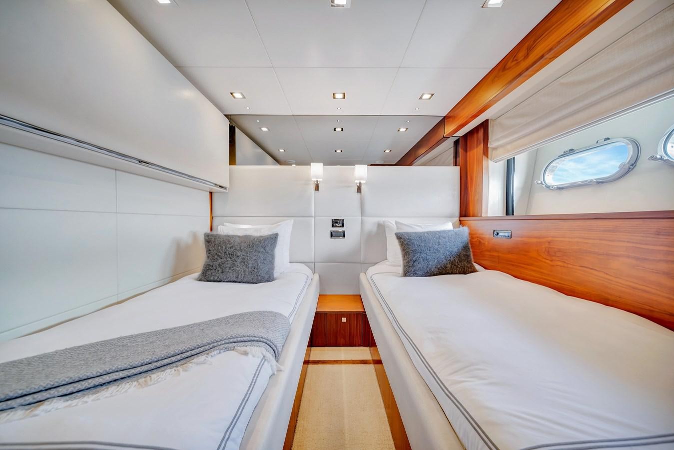 a room with beds and a wood floor aboard QUATTRO Yacht for Sale