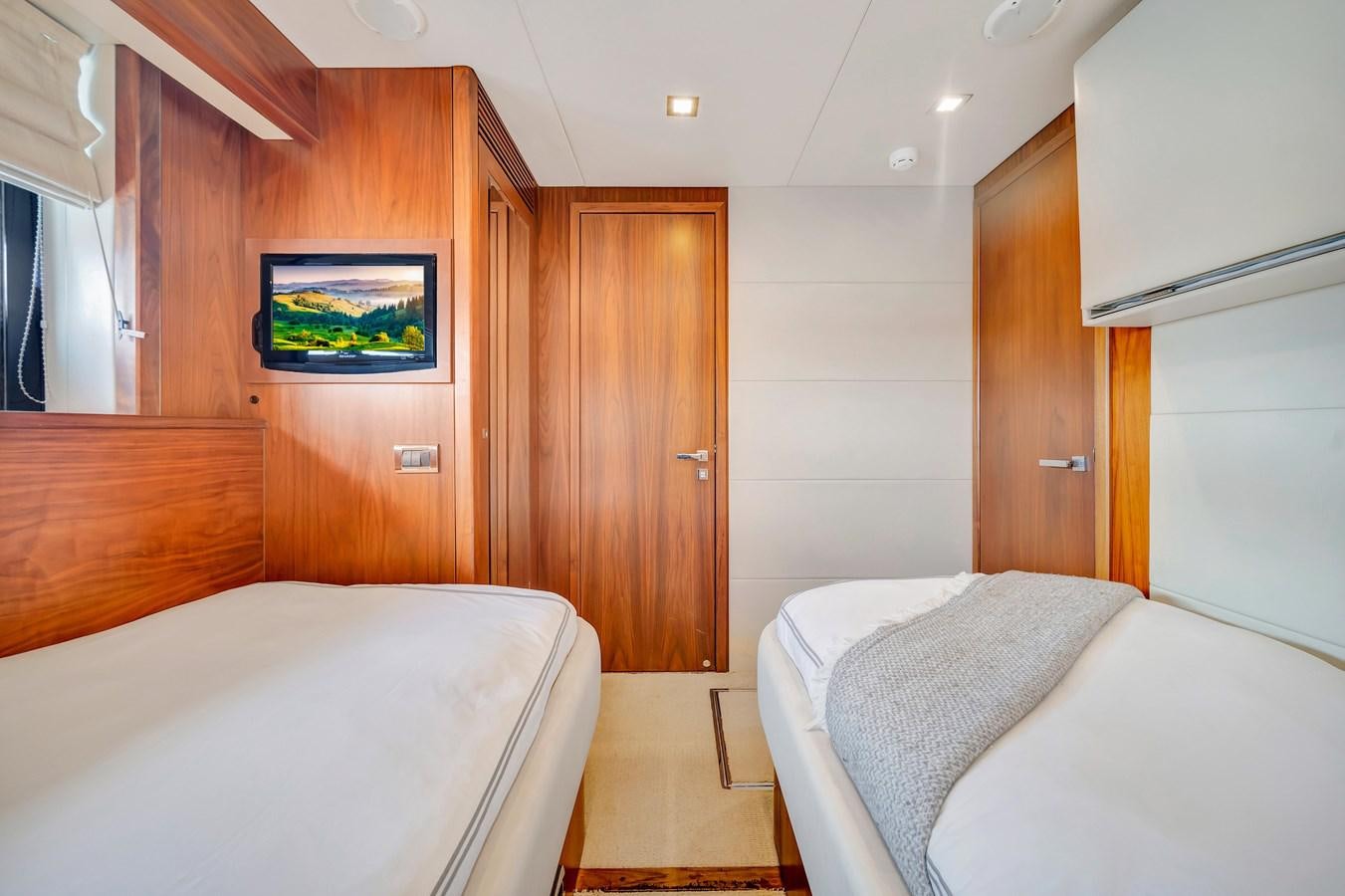 a room with a bed and a television aboard QUATTRO Yacht for Sale