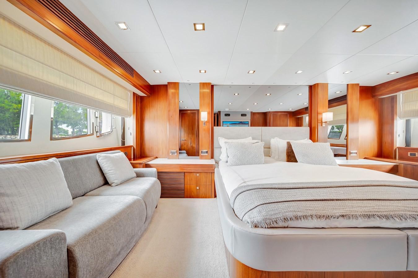 a room with a bed and a couch aboard QUATTRO Yacht for Sale