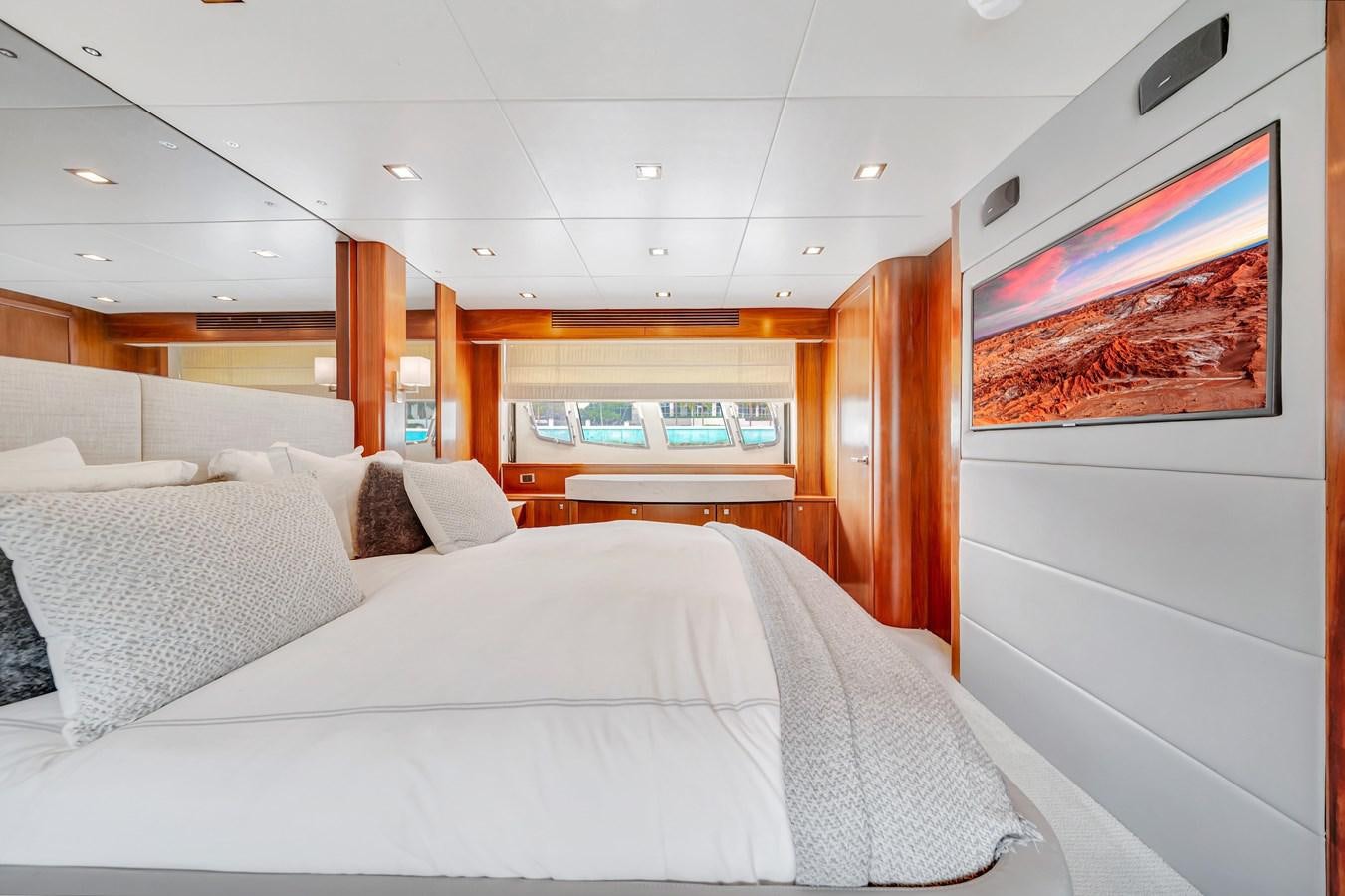 a room with a bed and a television on the wall aboard QUATTRO Yacht for Sale