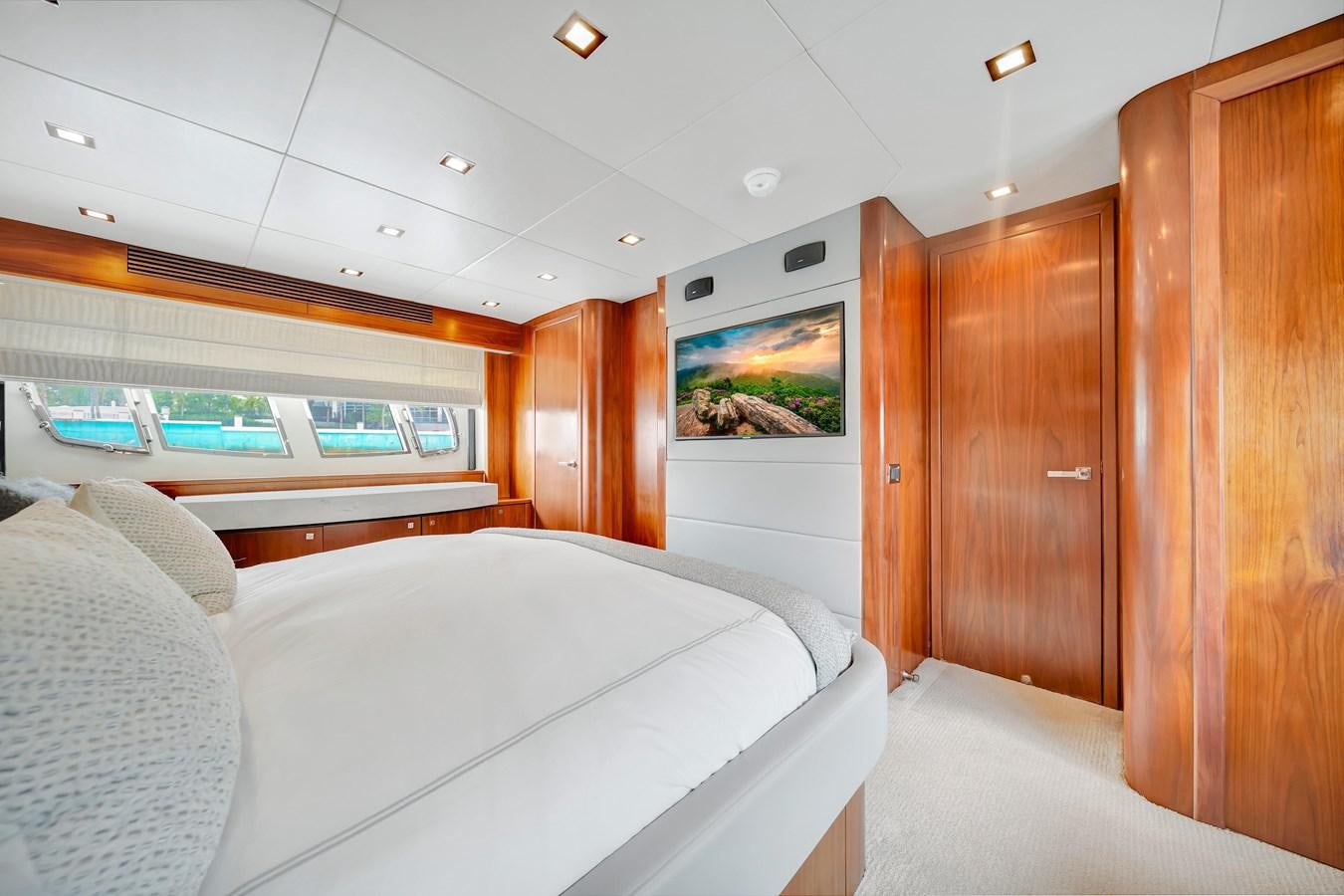 a room with a bed and a wood cabinet aboard QUATTRO Yacht for Sale