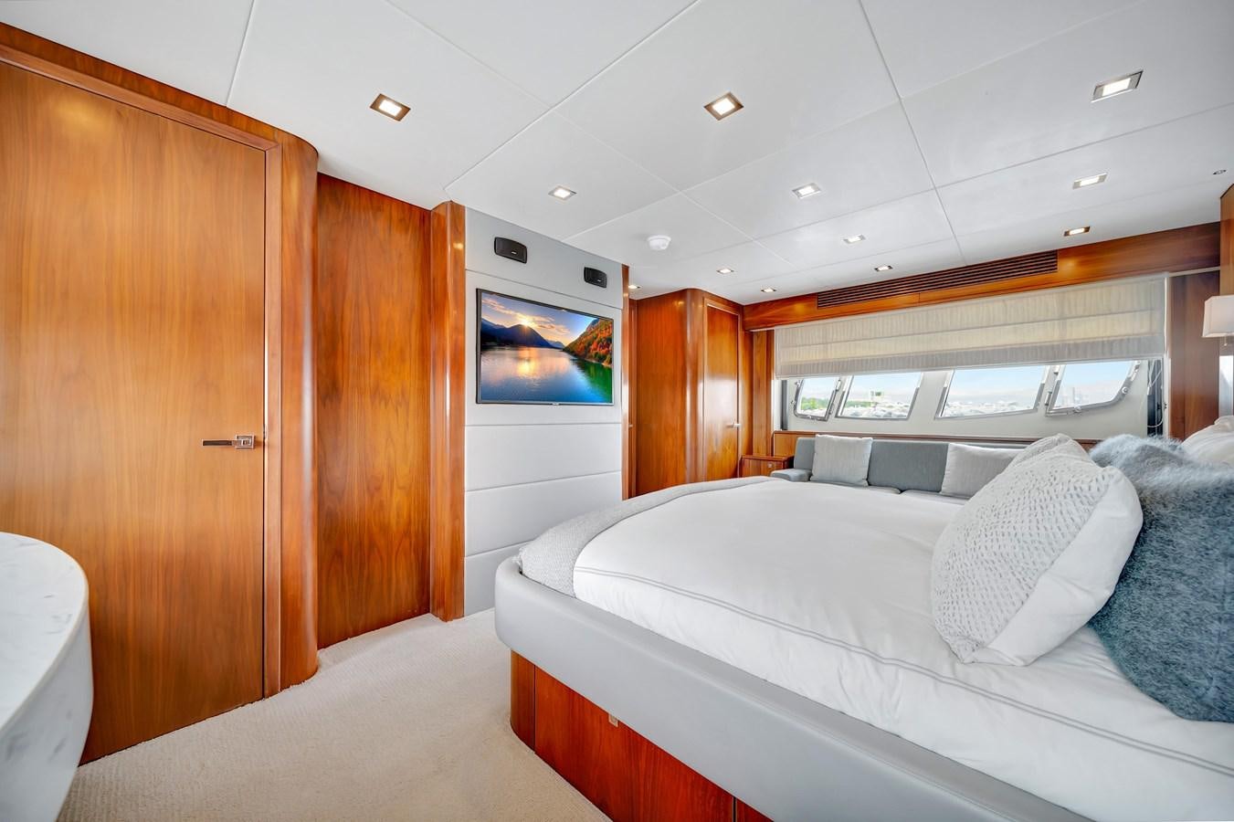 a room with a bed and a wood cabinet aboard QUATTRO Yacht for Sale