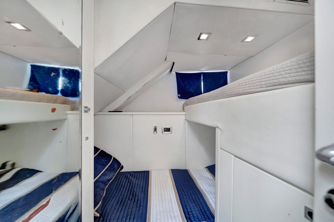 a room with white walls and blue flooring aboard QUATTRO Yacht for Sale