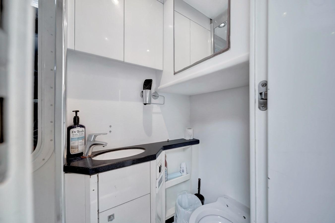 a kitchen with white cabinets aboard QUATTRO Yacht for Sale