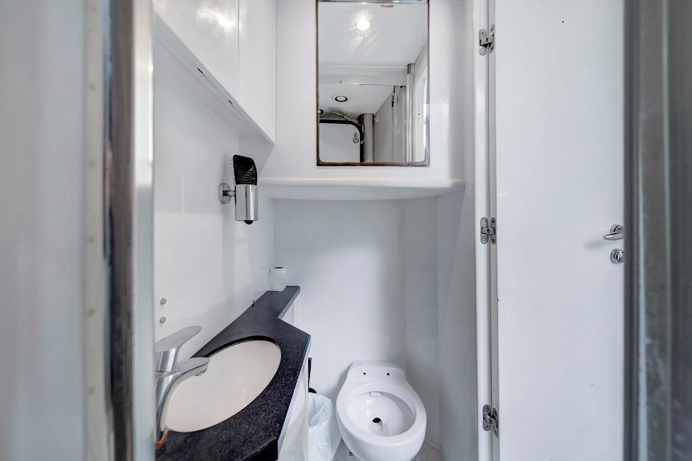 a bathroom with a toilet and a sink aboard QUATTRO Yacht for Sale