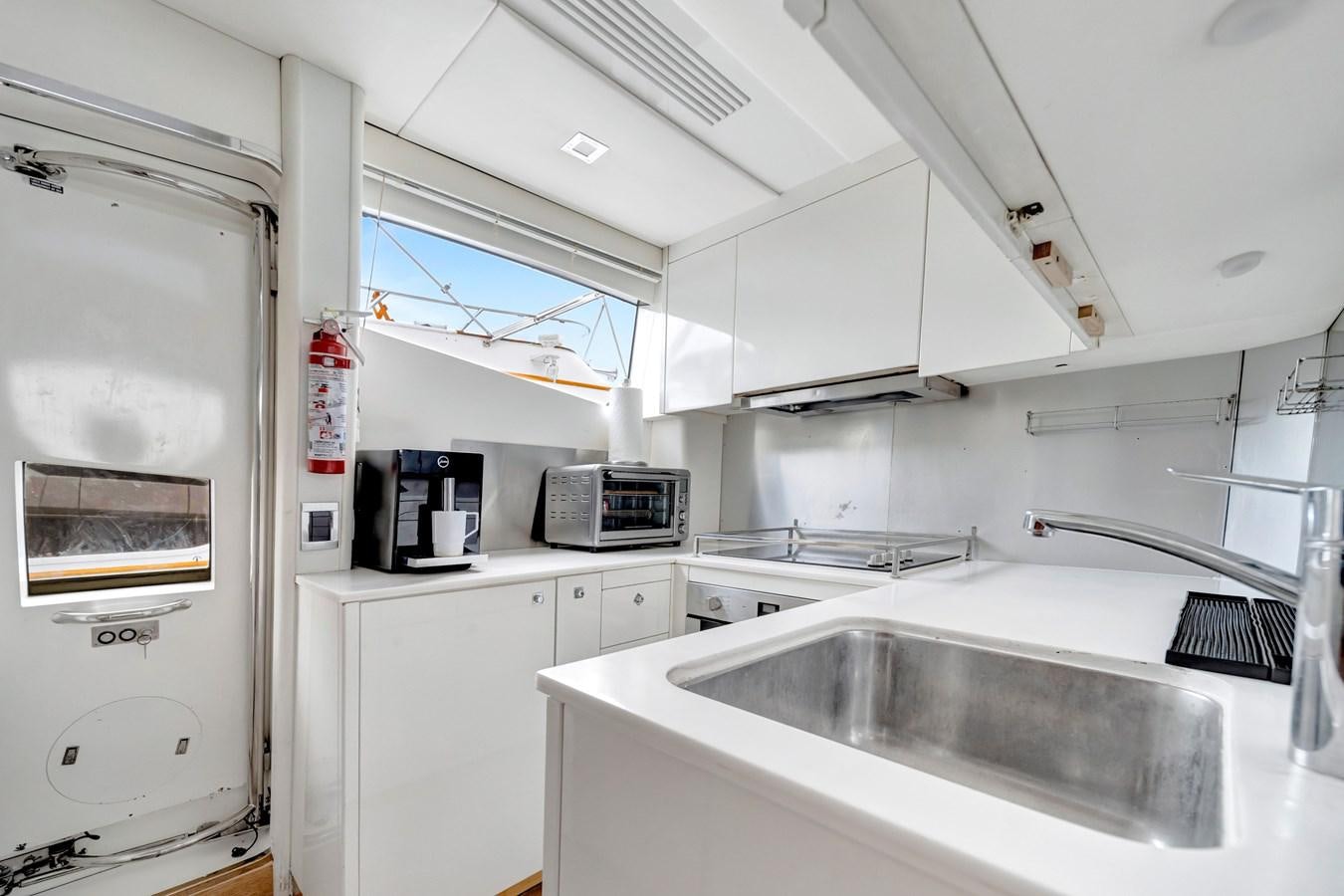 a kitchen with a sink and microwave aboard QUATTRO Yacht for Sale