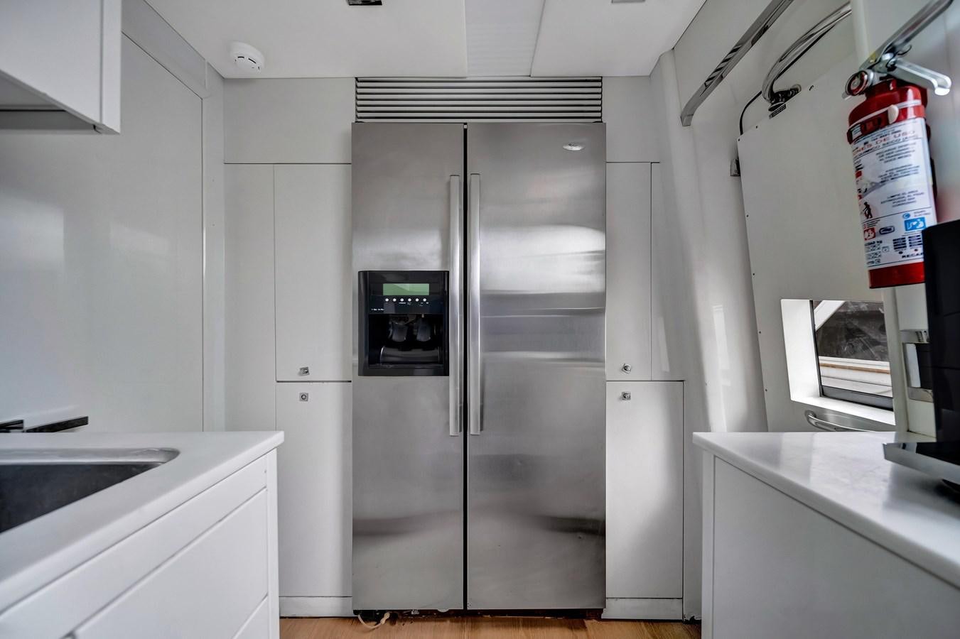 a stainless steel refrigerator in a kitchen aboard QUATTRO Yacht for Sale