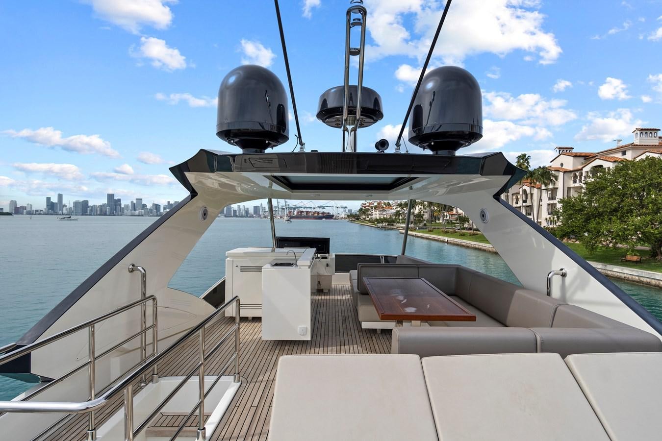 a deck with a large satellite dish on it and a body of water and blue sky with clouds aboard SAN PEDRO Yacht for Sale