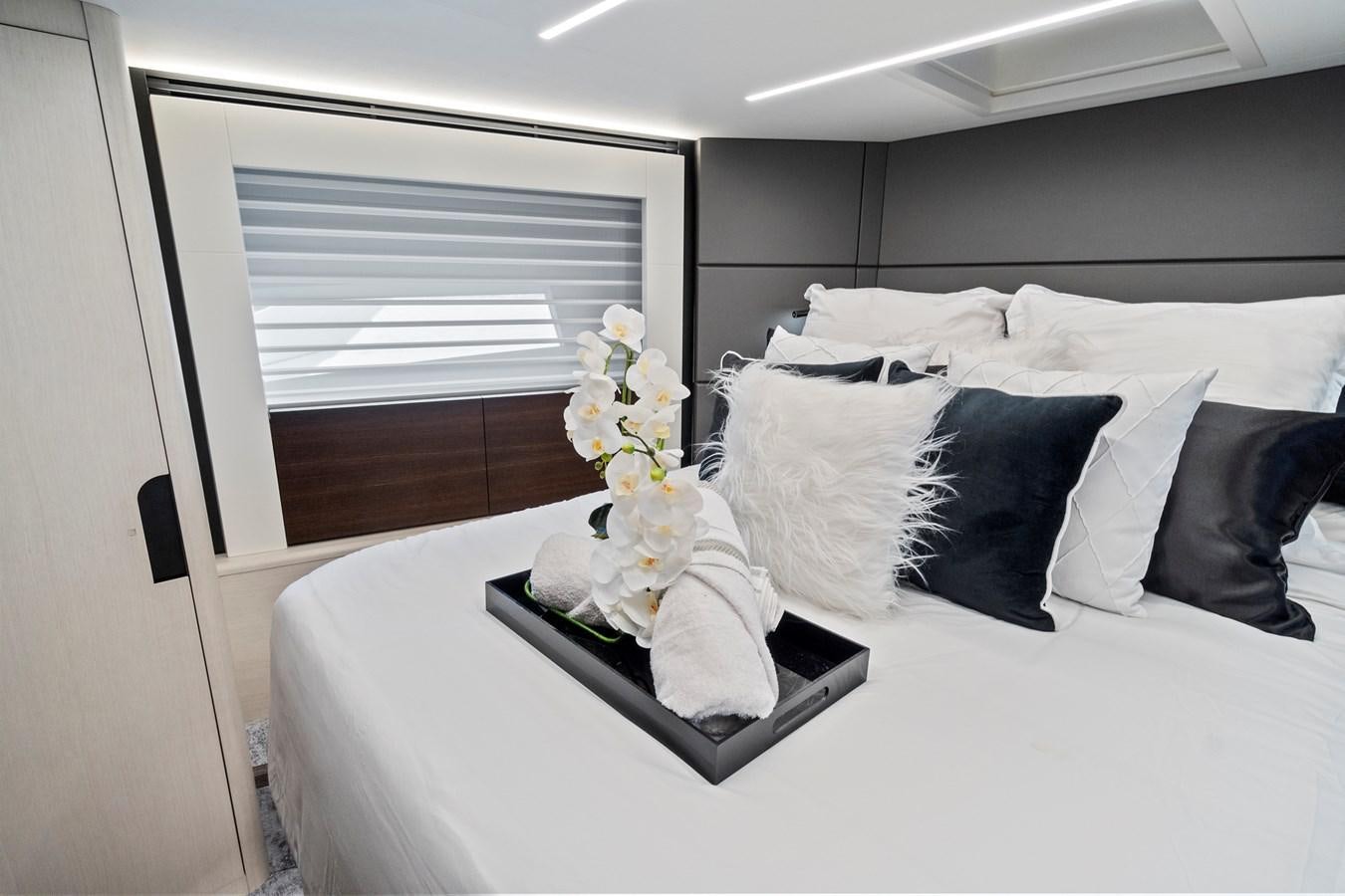 a bed with white sheets and pillows aboard SAN PEDRO Yacht for Sale