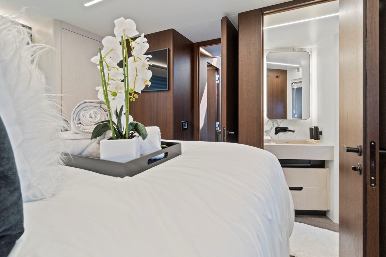 a white bed with white flowers aboard SAN PEDRO Yacht for Sale