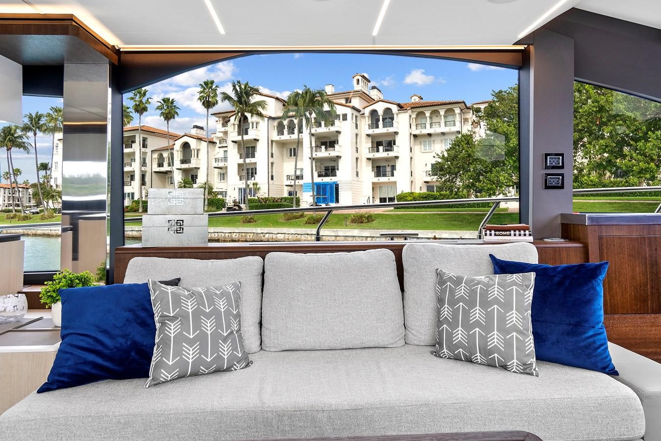 a couch with pillows in front of a building aboard SAN PEDRO Yacht for Sale