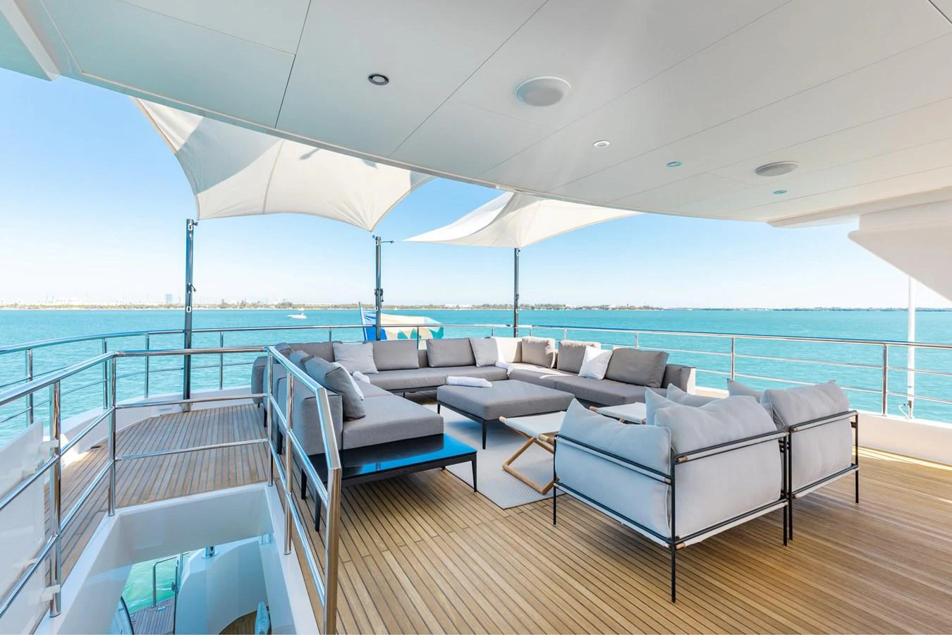 a large living room with a large balcony overlooking the ocean aboard ADAGIO Yacht for Sale