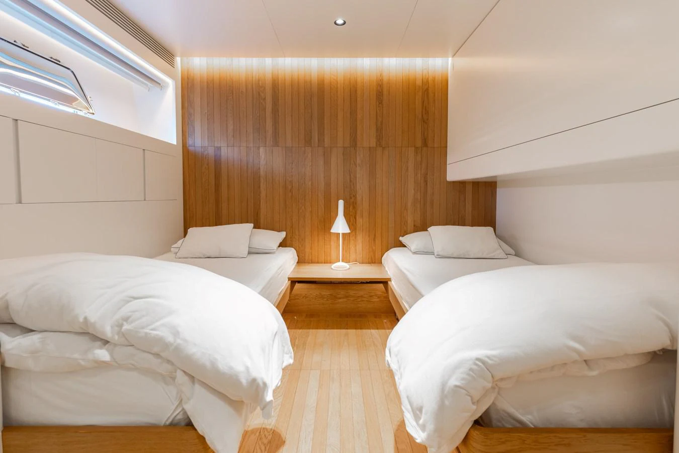 a room with a bed and a table aboard ADAGIO Yacht for Sale