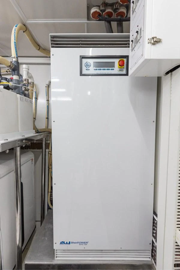 a white refrigerator with a blue handle aboard ADAGIO Yacht for Sale