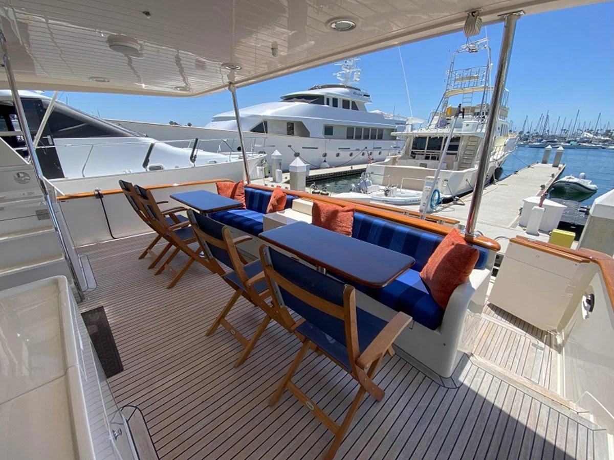 a deck with a boat and chairs aboard TEMPUS FUGIT II Yacht for Sale