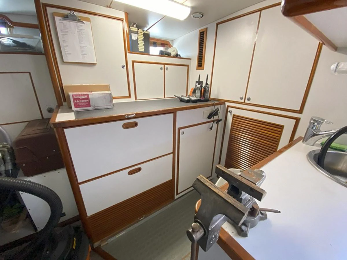 a kitchen with a sink and cabinets aboard TEMPUS FUGIT II Yacht for Sale