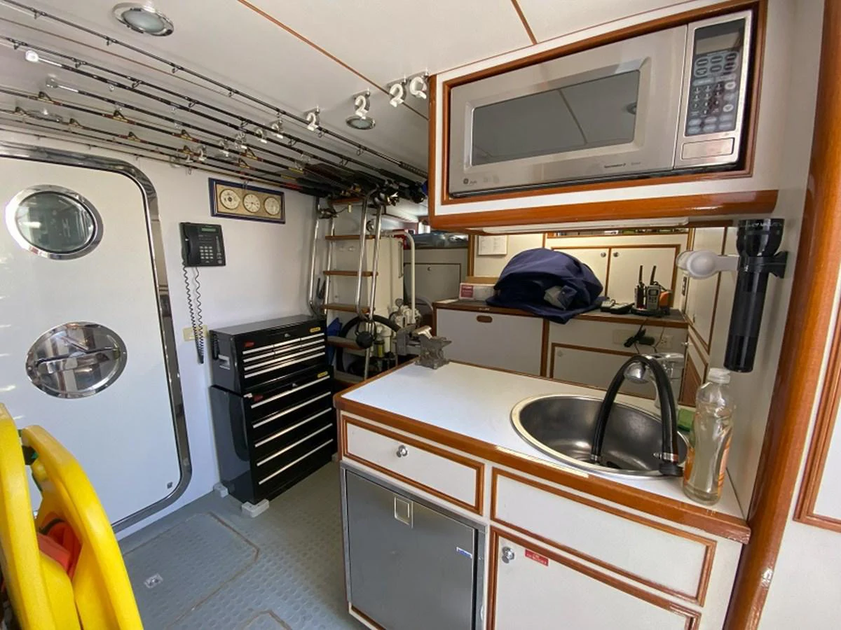 a small kitchen with a microwave oven aboard TEMPUS FUGIT II Yacht for Sale