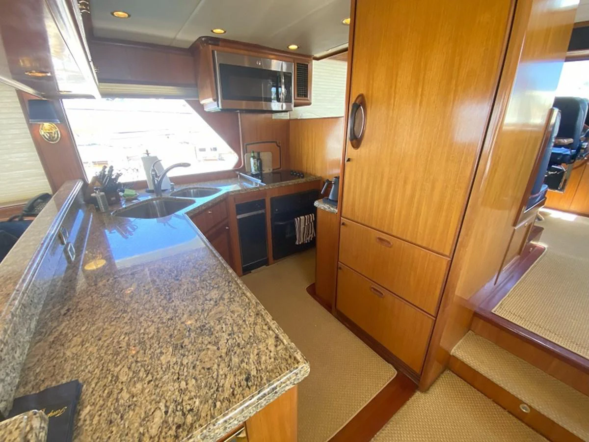 a kitchen with a large island aboard TEMPUS FUGIT II Yacht for Sale