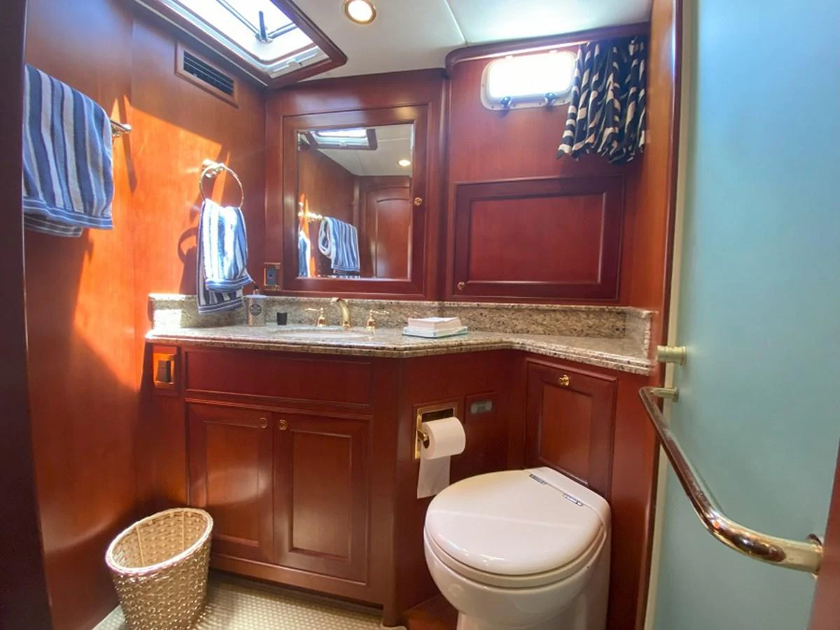 a bathroom with a sink toilet and a mirror aboard TEMPUS FUGIT II Yacht for Sale