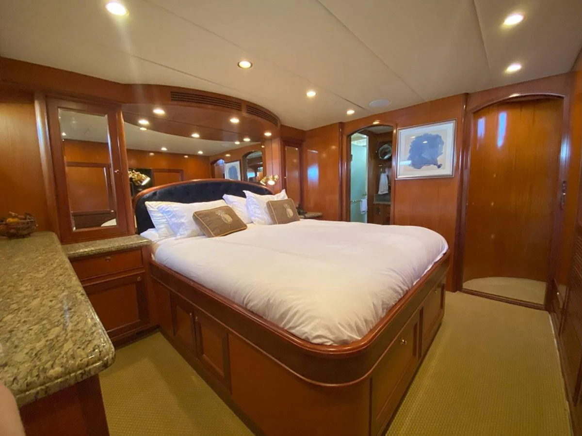 a bedroom with a bed and a mirror aboard TEMPUS FUGIT II Yacht for Sale
