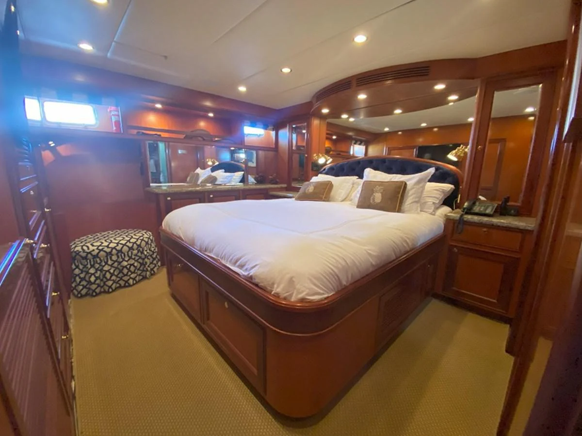 a room with a bed and a mirror aboard TEMPUS FUGIT II Yacht for Sale