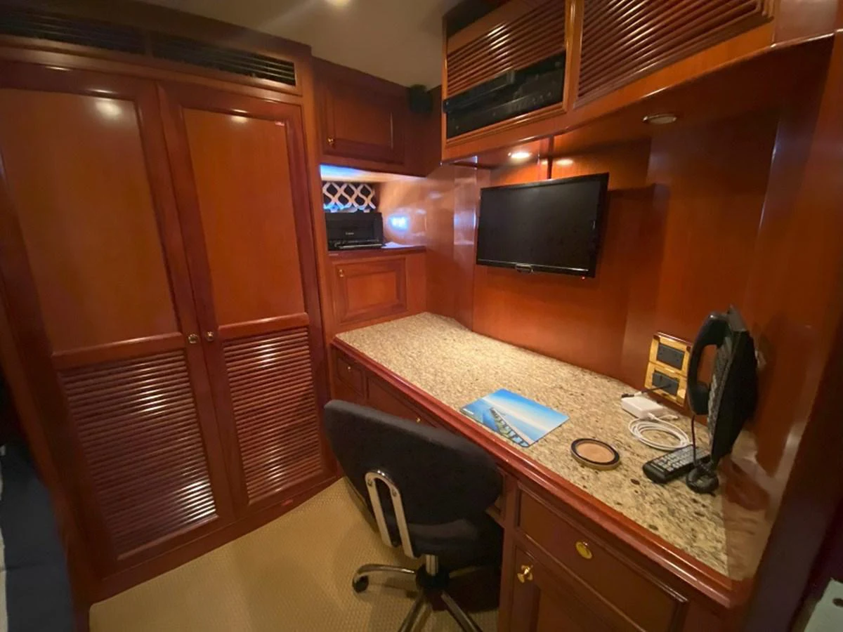 a room with a tv and a table aboard TEMPUS FUGIT II Yacht for Sale