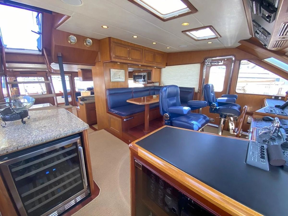 a room with a table and chairs aboard TEMPUS FUGIT II Yacht for Sale
