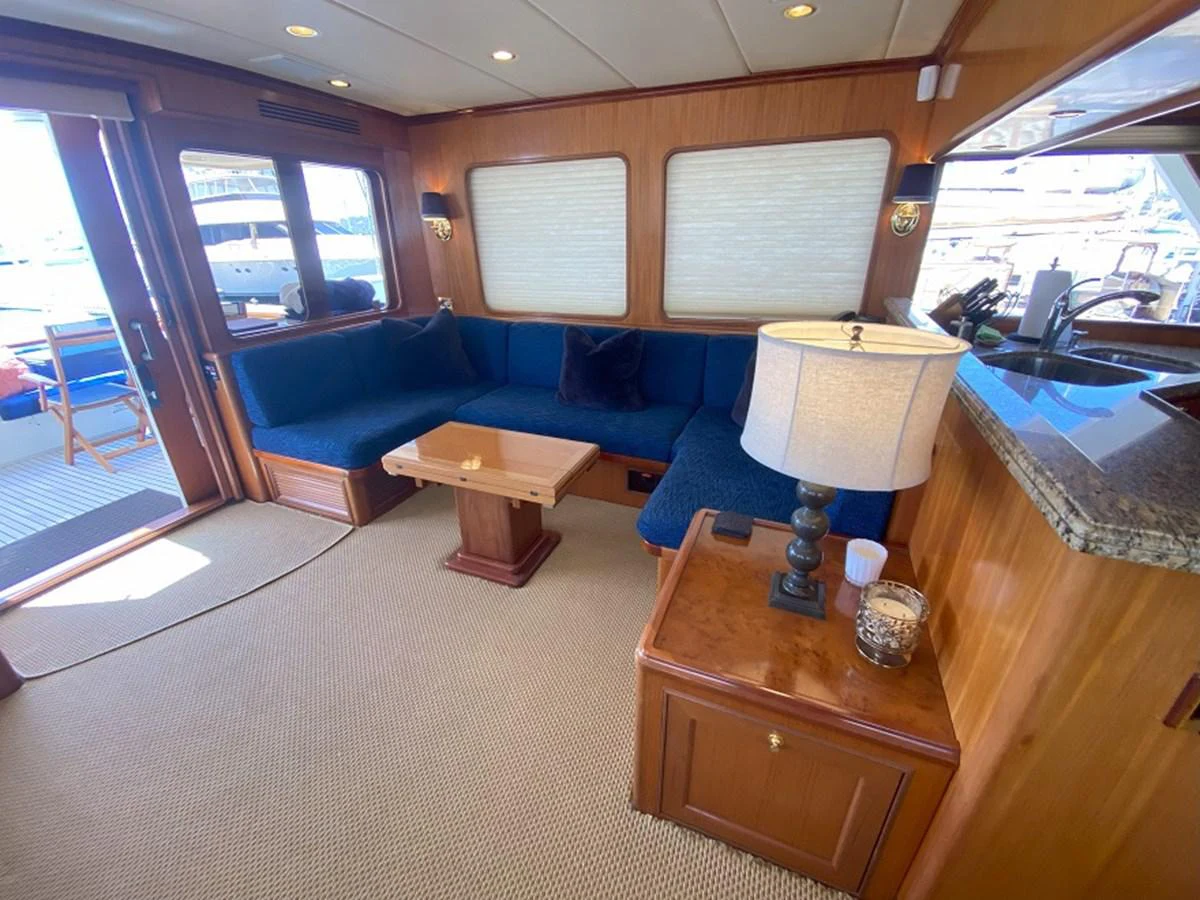 a room with a couch and a table aboard TEMPUS FUGIT II Yacht for Sale