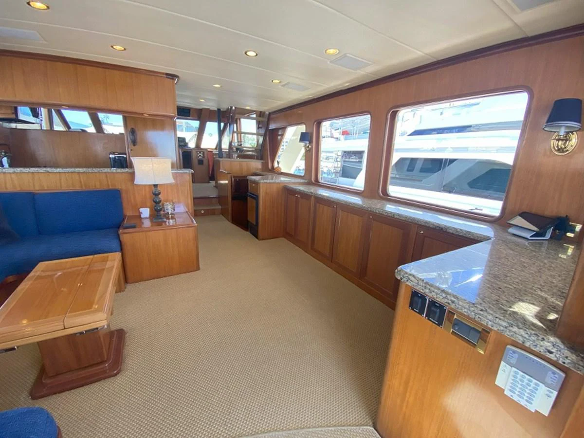 a room with a couch and a television aboard TEMPUS FUGIT II Yacht for Sale