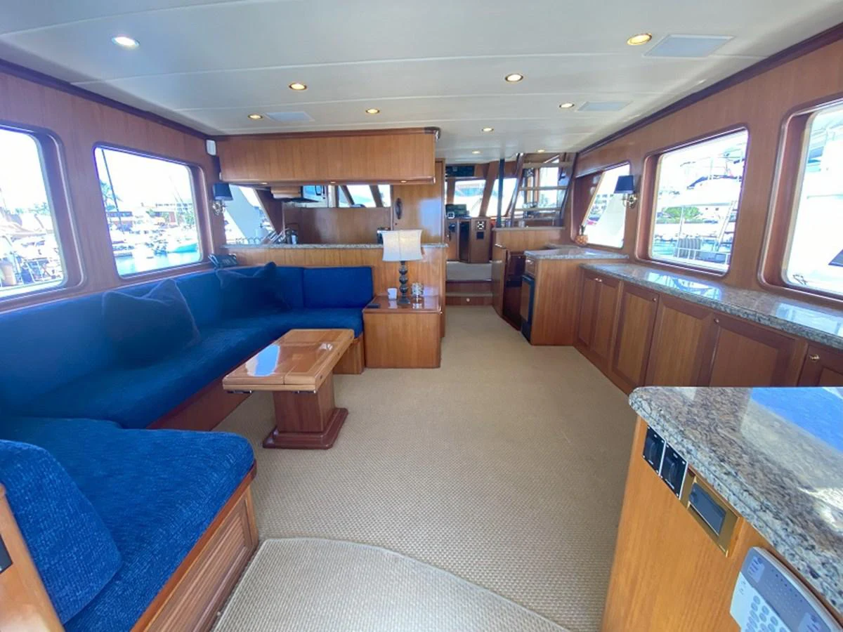 a room with a couch and a table aboard TEMPUS FUGIT II Yacht for Sale