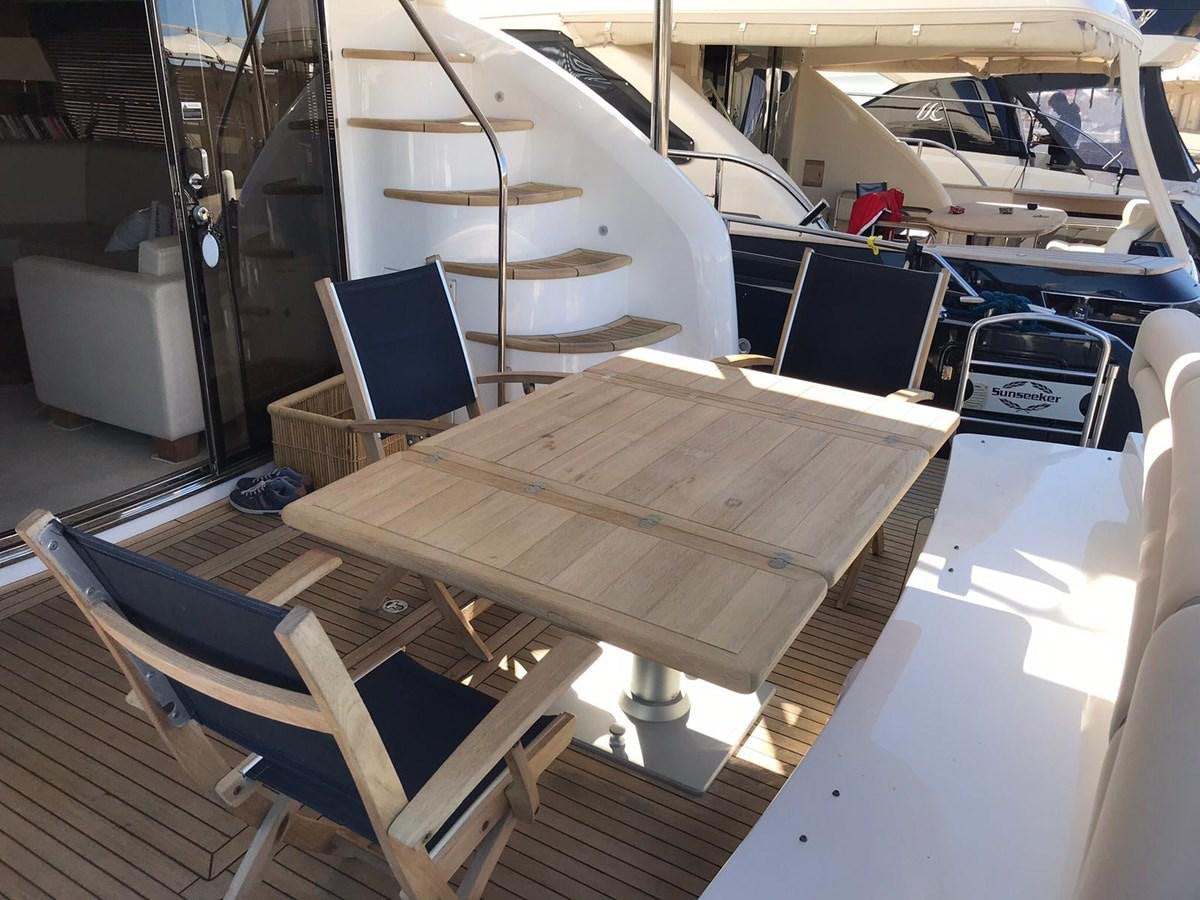 a table with chairs on it aboard MANHATTAN 70 Yacht for Sale