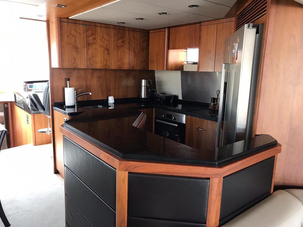 a kitchen with wooden cabinets aboard MANHATTAN 70 Yacht for Sale