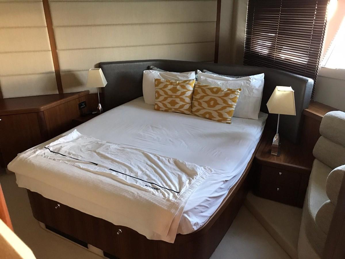 a bed with a white comforter aboard MANHATTAN 70 Yacht for Sale