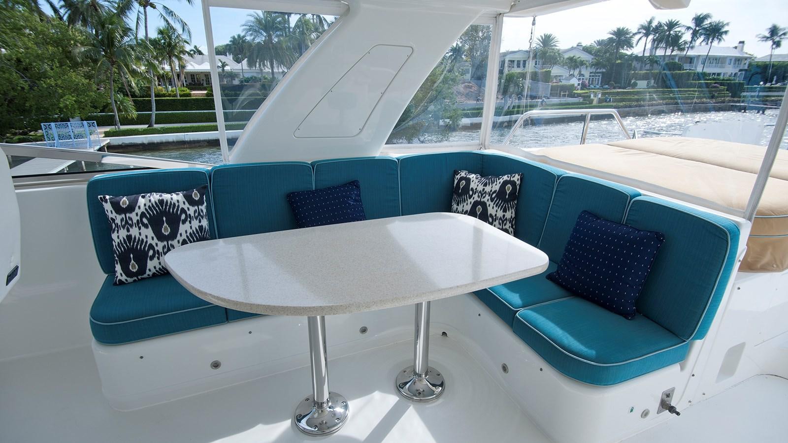 a white table with blue pillows on it aboard MONCRII Yacht for Sale