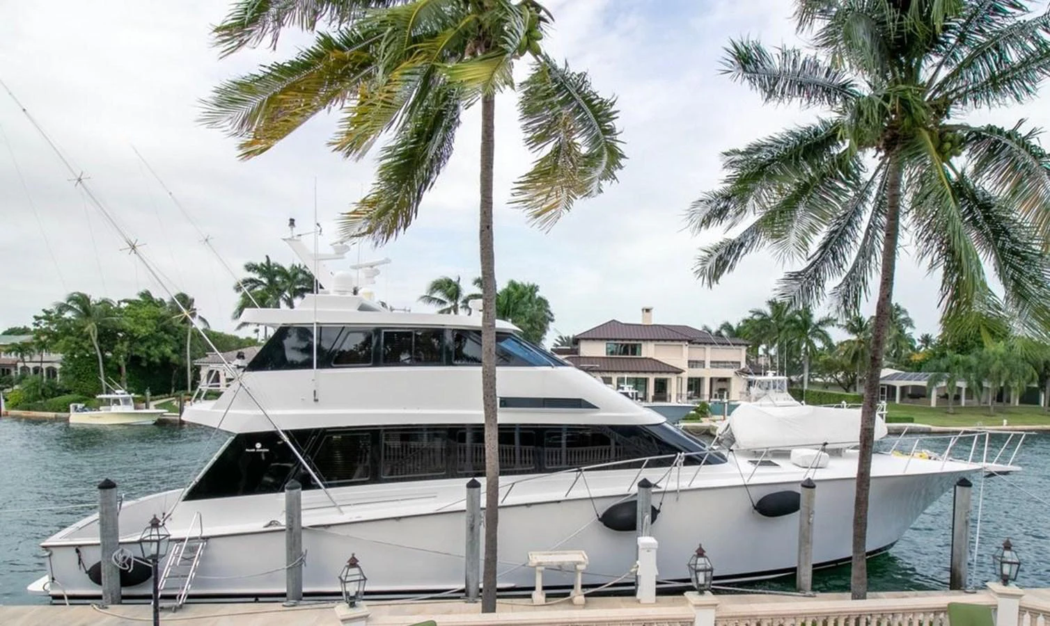 a white boat with palm trees aboard CHAIRMAN Yacht for Sale
