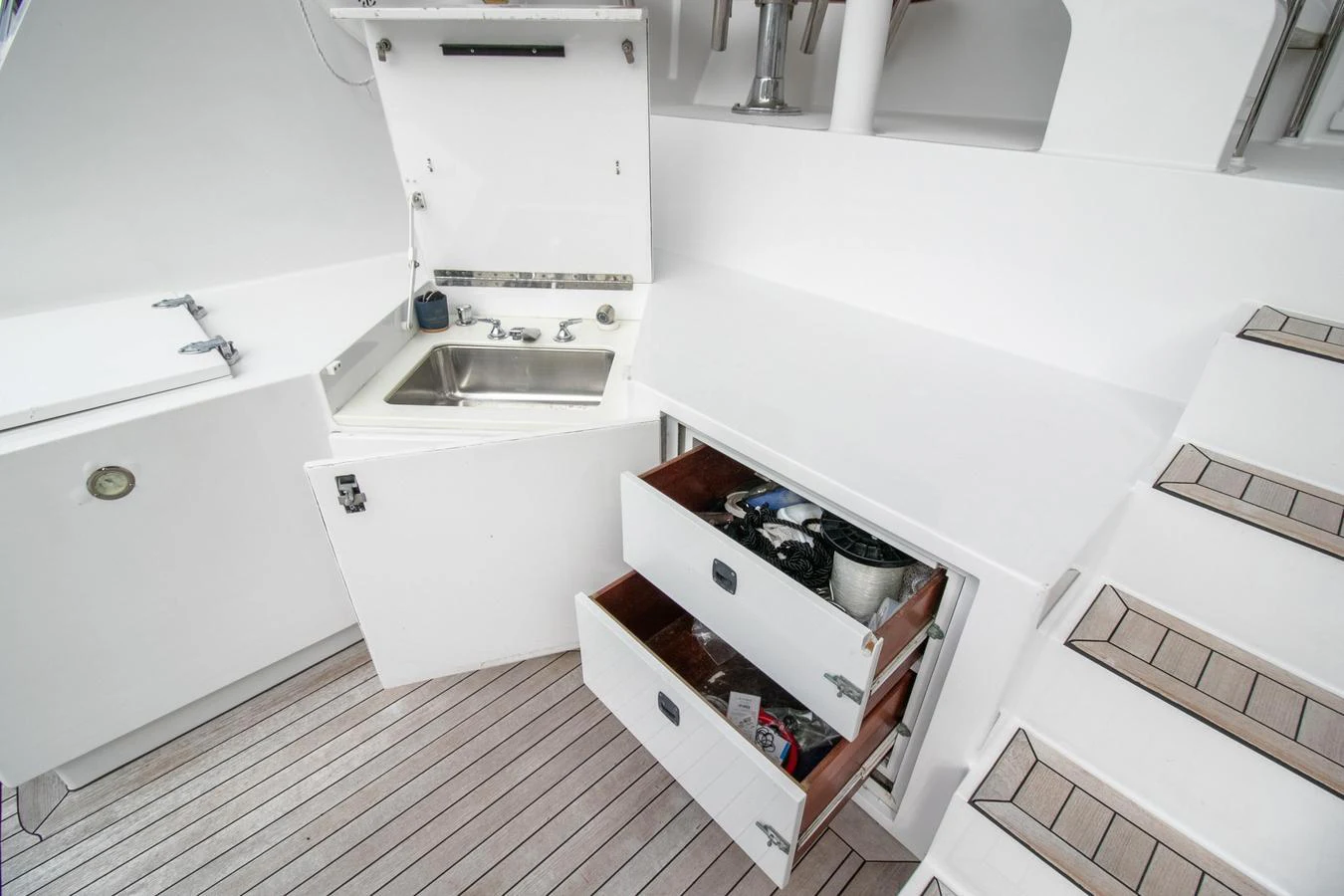 a white kitchen with a sink and cabinets aboard CHAIRMAN Yacht for Sale