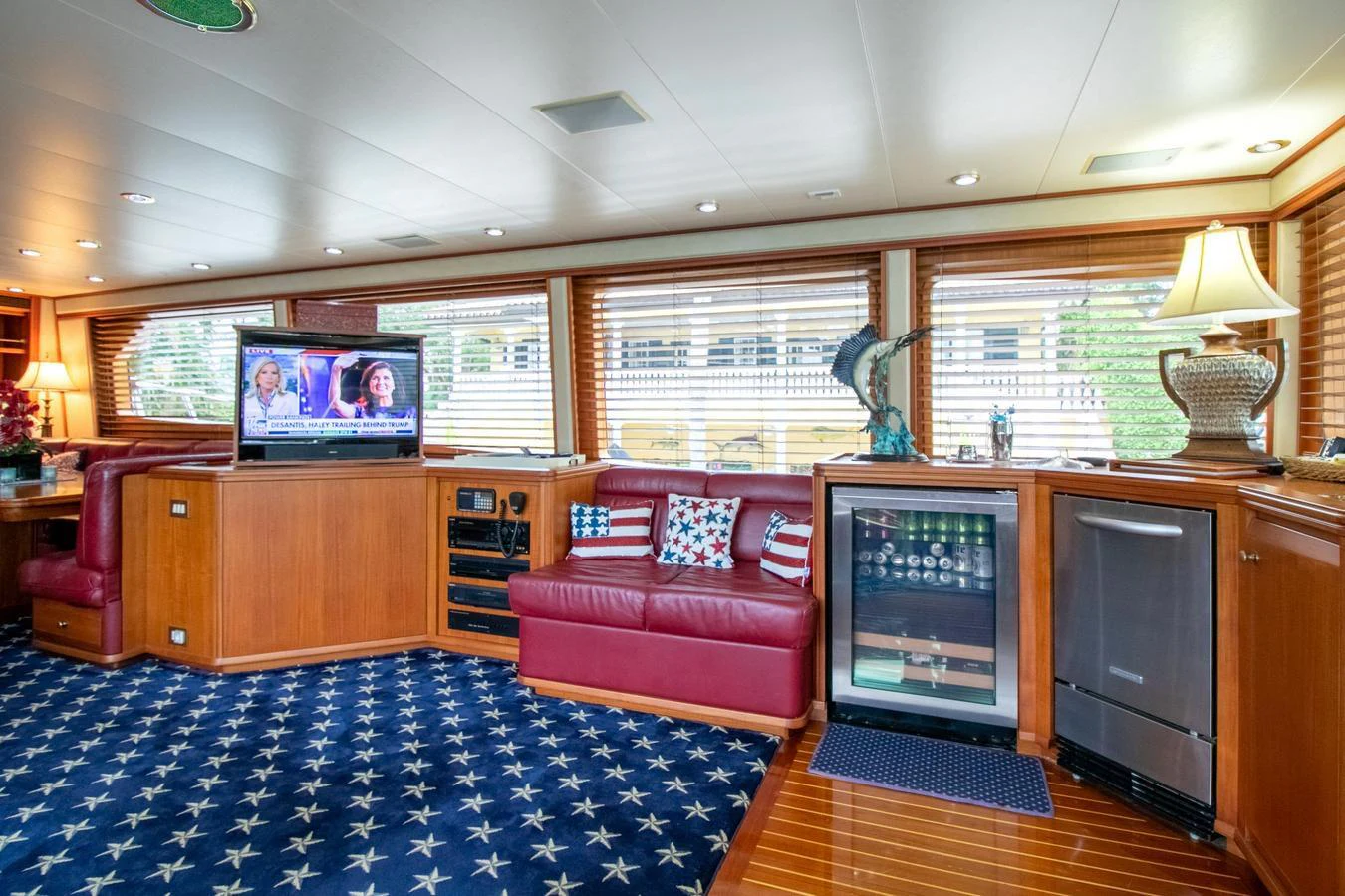 a living room with a red couch aboard CHAIRMAN Yacht for Sale