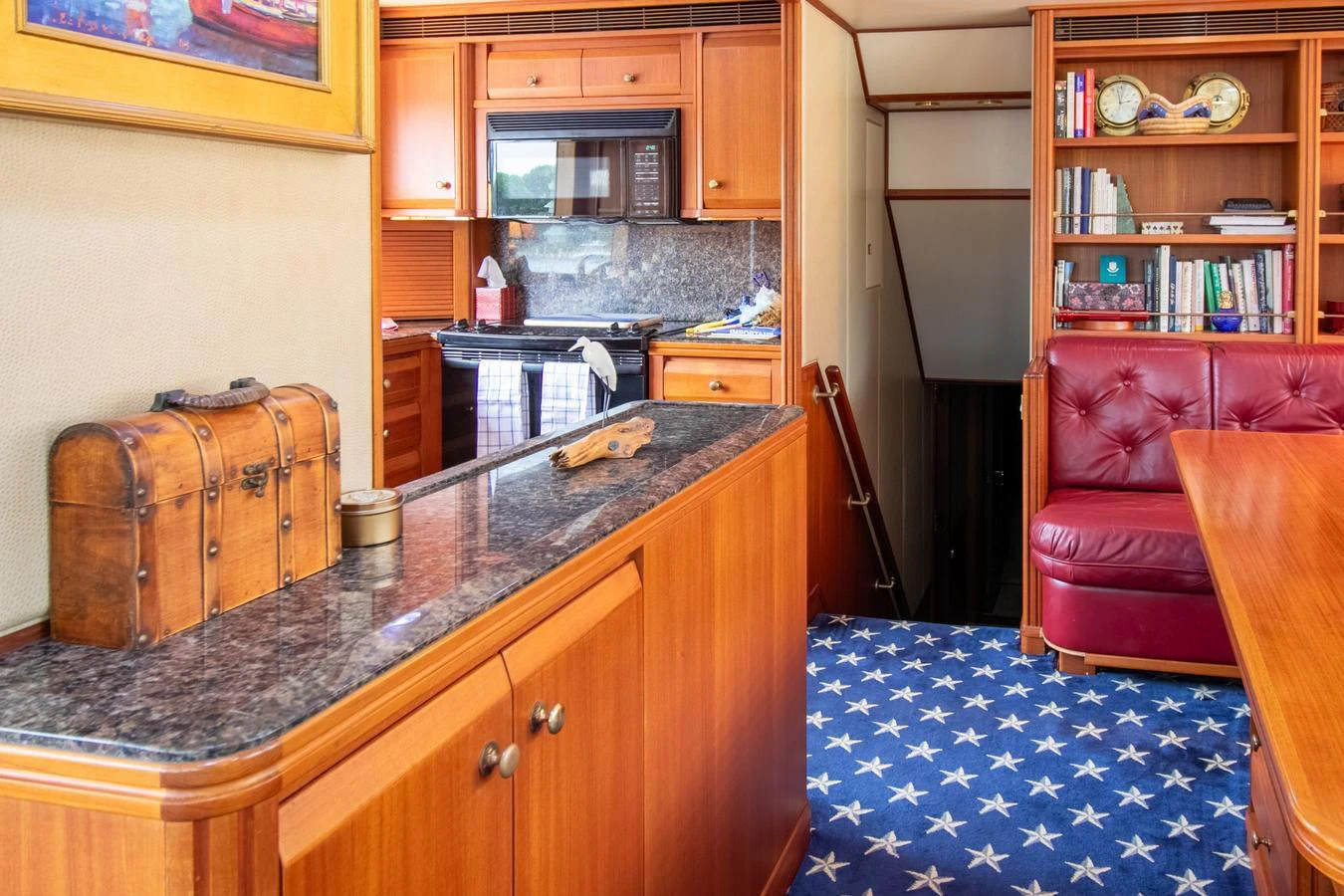 a kitchen with a red couch aboard CHAIRMAN Yacht for Sale