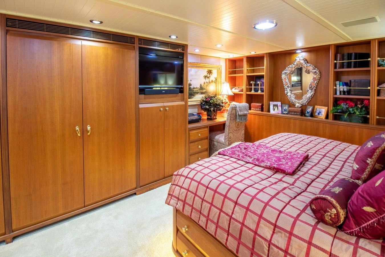 a bedroom with a bed and cabinets aboard CHAIRMAN Yacht for Sale