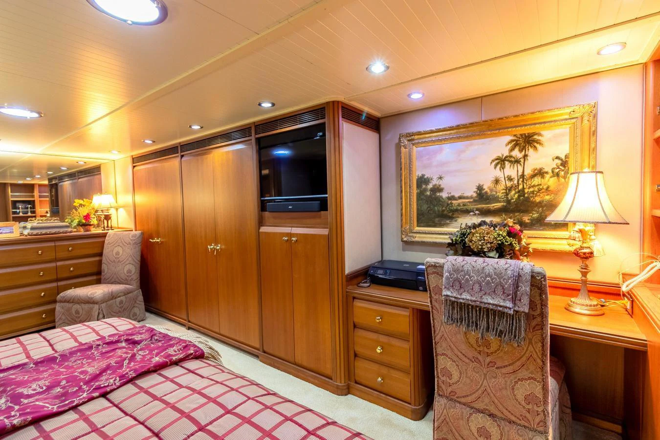 a bedroom with a bed and a chair aboard CHAIRMAN Yacht for Sale