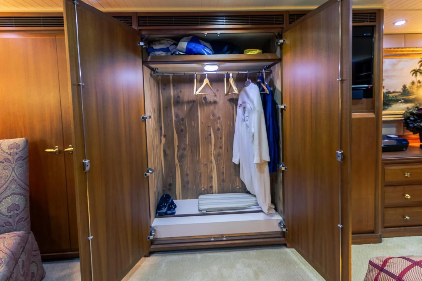 a closet with clothes on the rack aboard CHAIRMAN Yacht for Sale