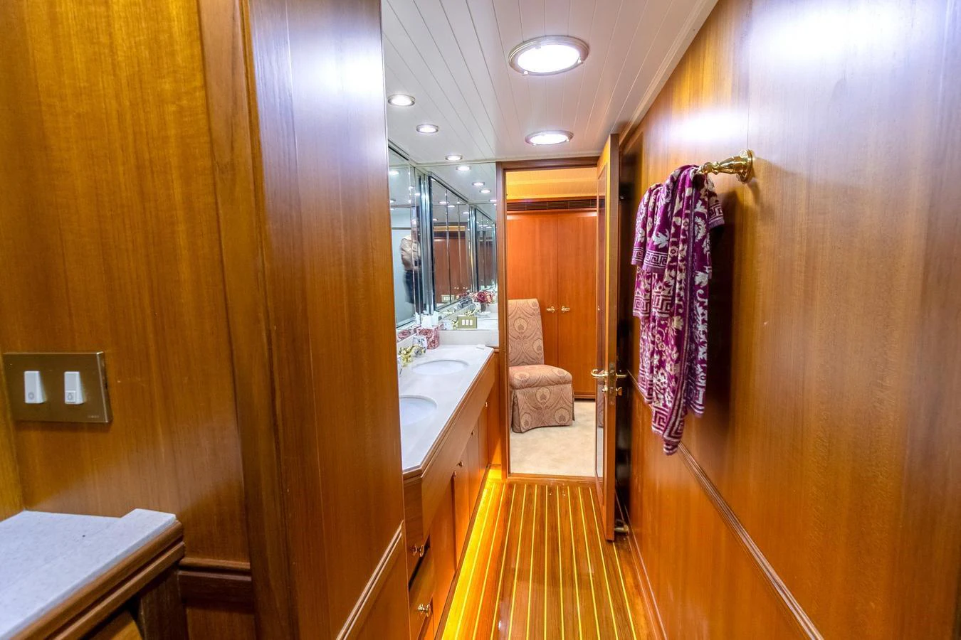 a bathroom with a wood door aboard CHAIRMAN Yacht for Sale