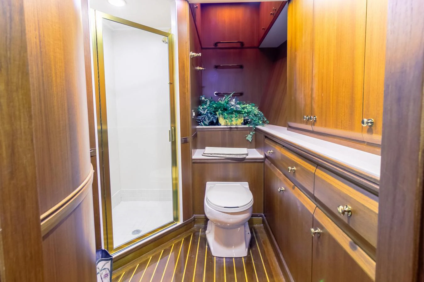 a bathroom with a toilet and cabinets aboard CHAIRMAN Yacht for Sale