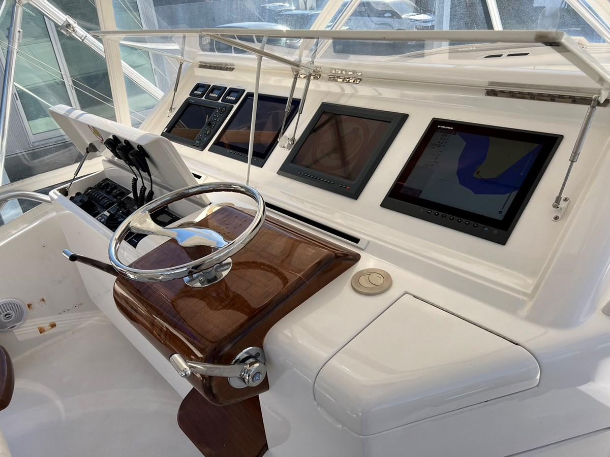 a car with a screen and a steering wheel aboard FORWARD Yacht for Sale