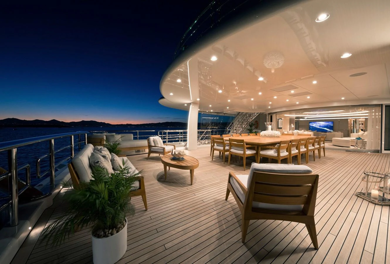 a deck with a table and chairs aboard NEW SECRET Yacht for Sale
