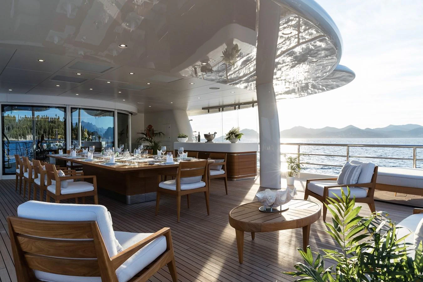 a room with a table chairs and plants aboard NEW SECRET Yacht for Sale