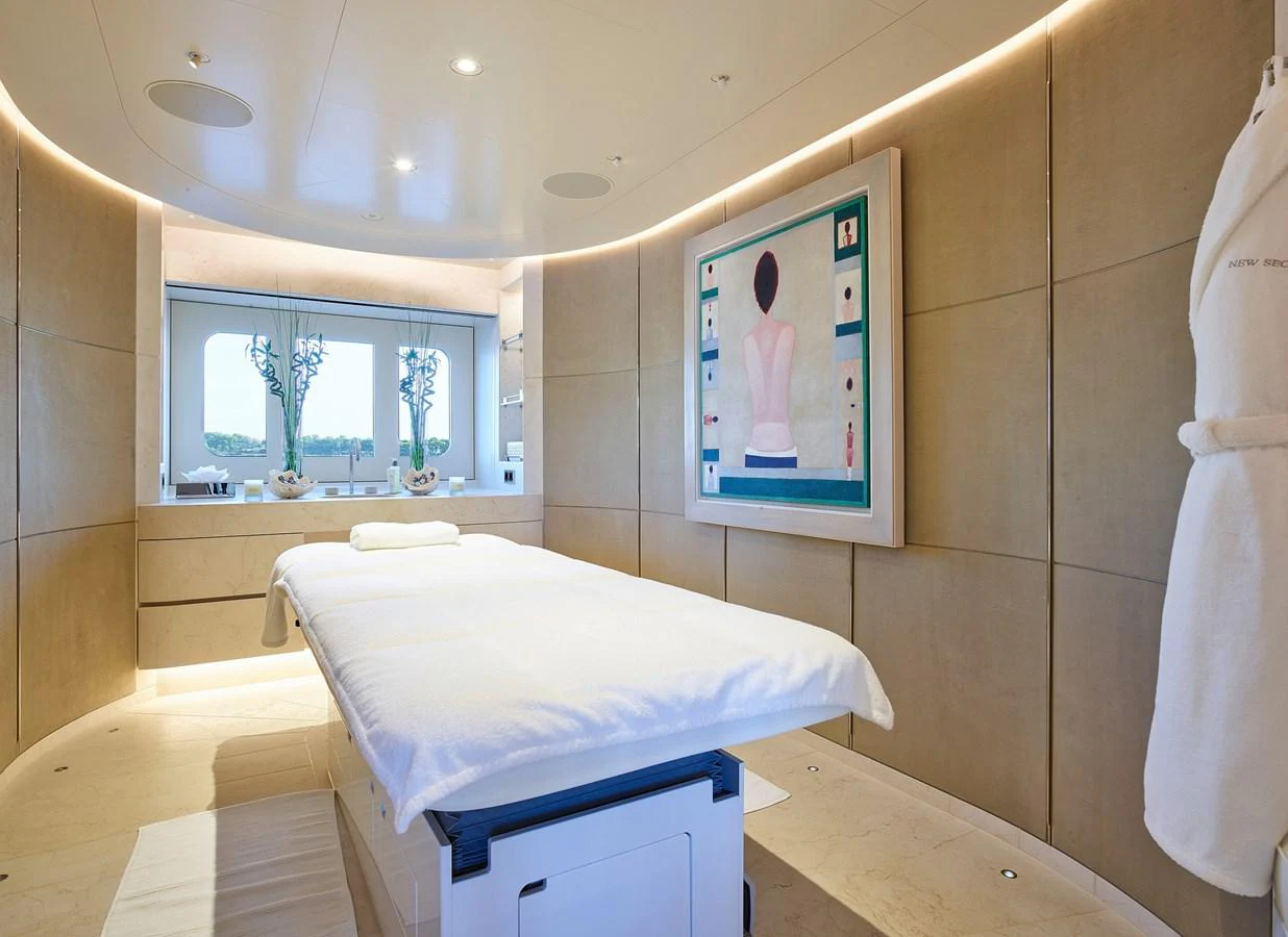 a room with a bed and a painting on the wall aboard NEW SECRET Yacht for Sale