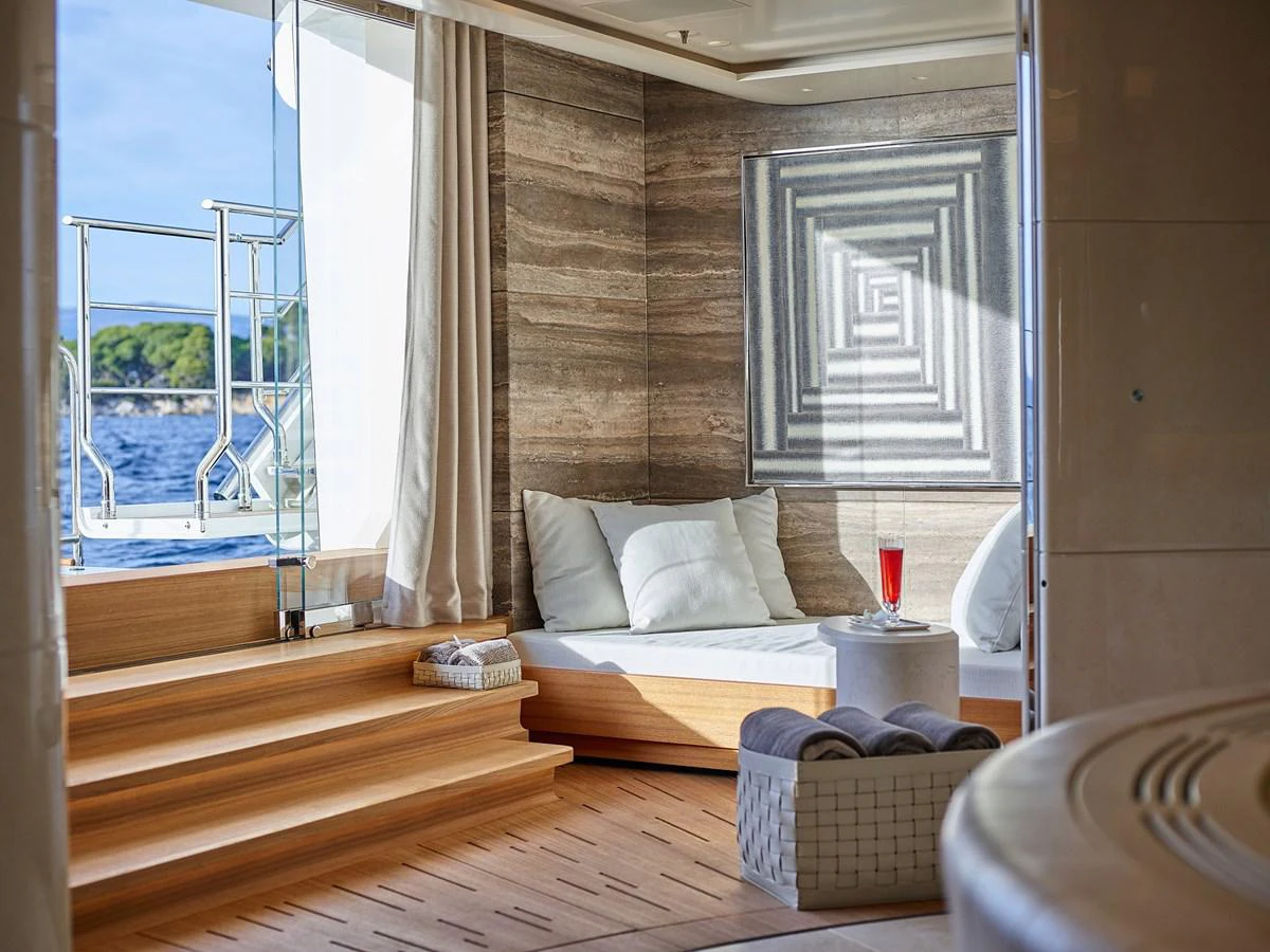 a bed and a table in a room aboard NEW SECRET Yacht for Sale