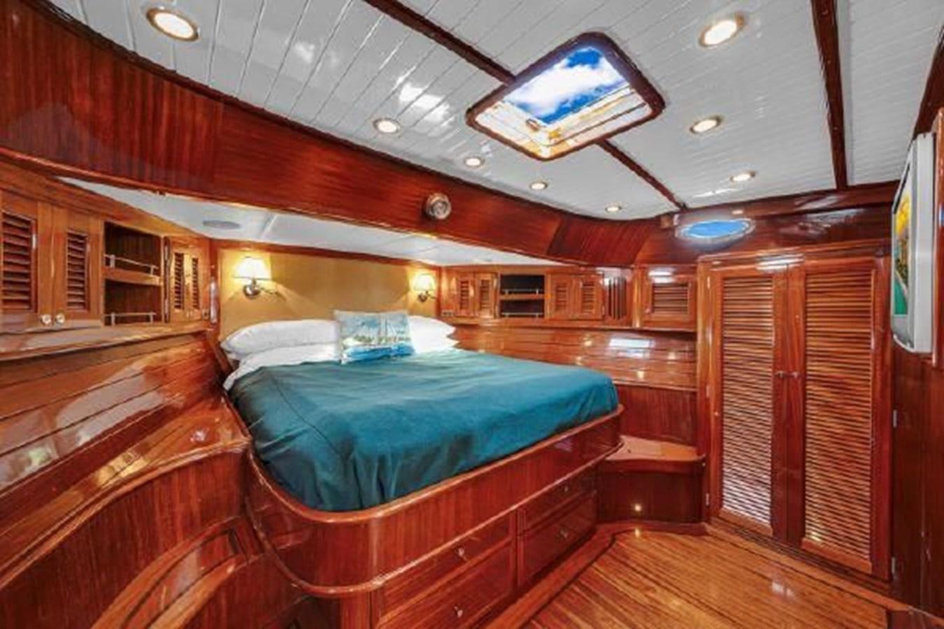 a room with a bed and a wood closet aboard TRUANT Yacht for Sale